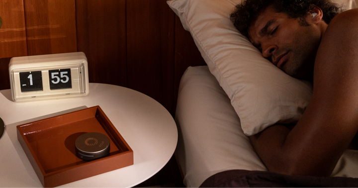 man sleeping with sleepbuds on his left side 